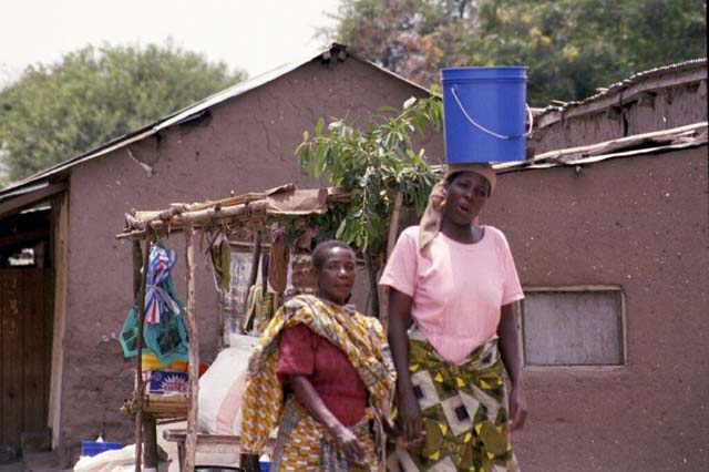 Woman balancing bucket on her head